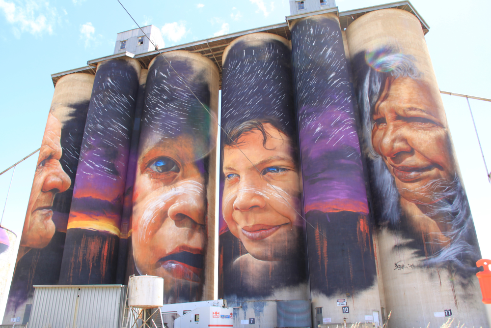 First nations peoples faces painted on large Cylinders